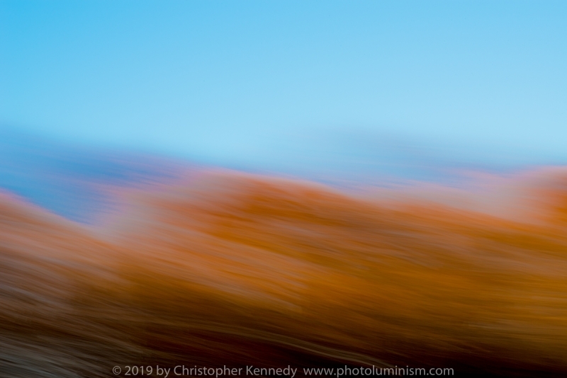 Force 10 A strong wind blows sand of the tops of abstract dunes under a bright blue sky