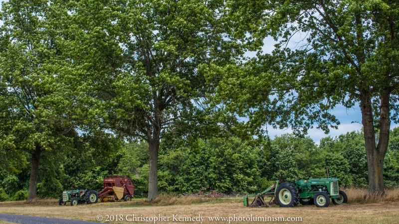 Two Tractors Under the Trees